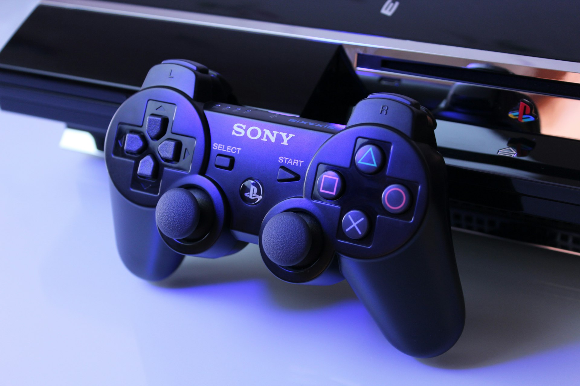 Black PlayStation 2 controller on white surface